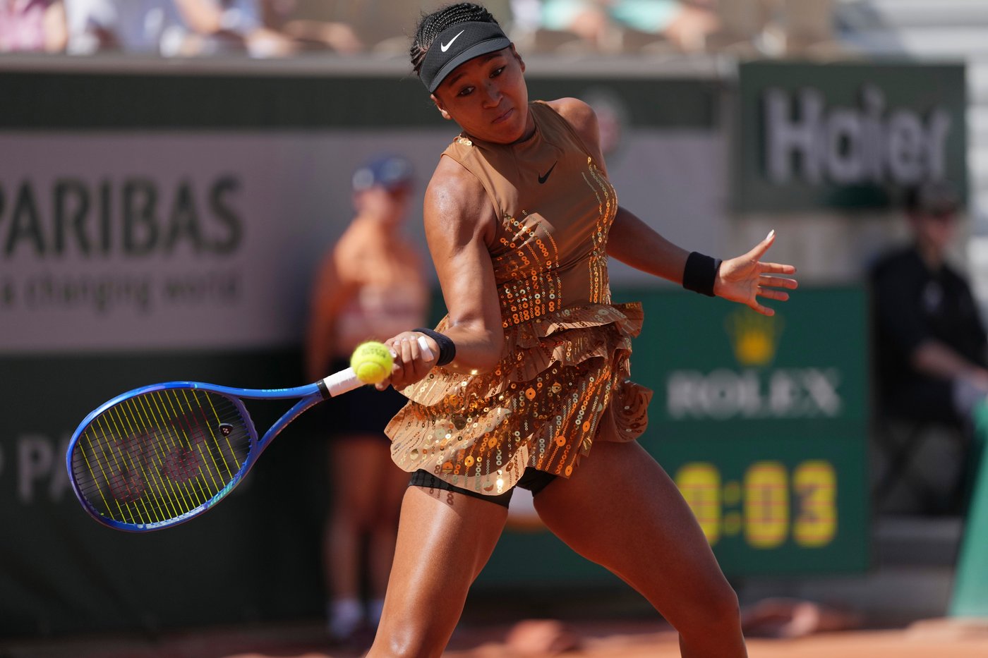 Naomi Osaka's latest French Open fashion ensemble includes an ivory train and gold jacket | iNFOnews.ca