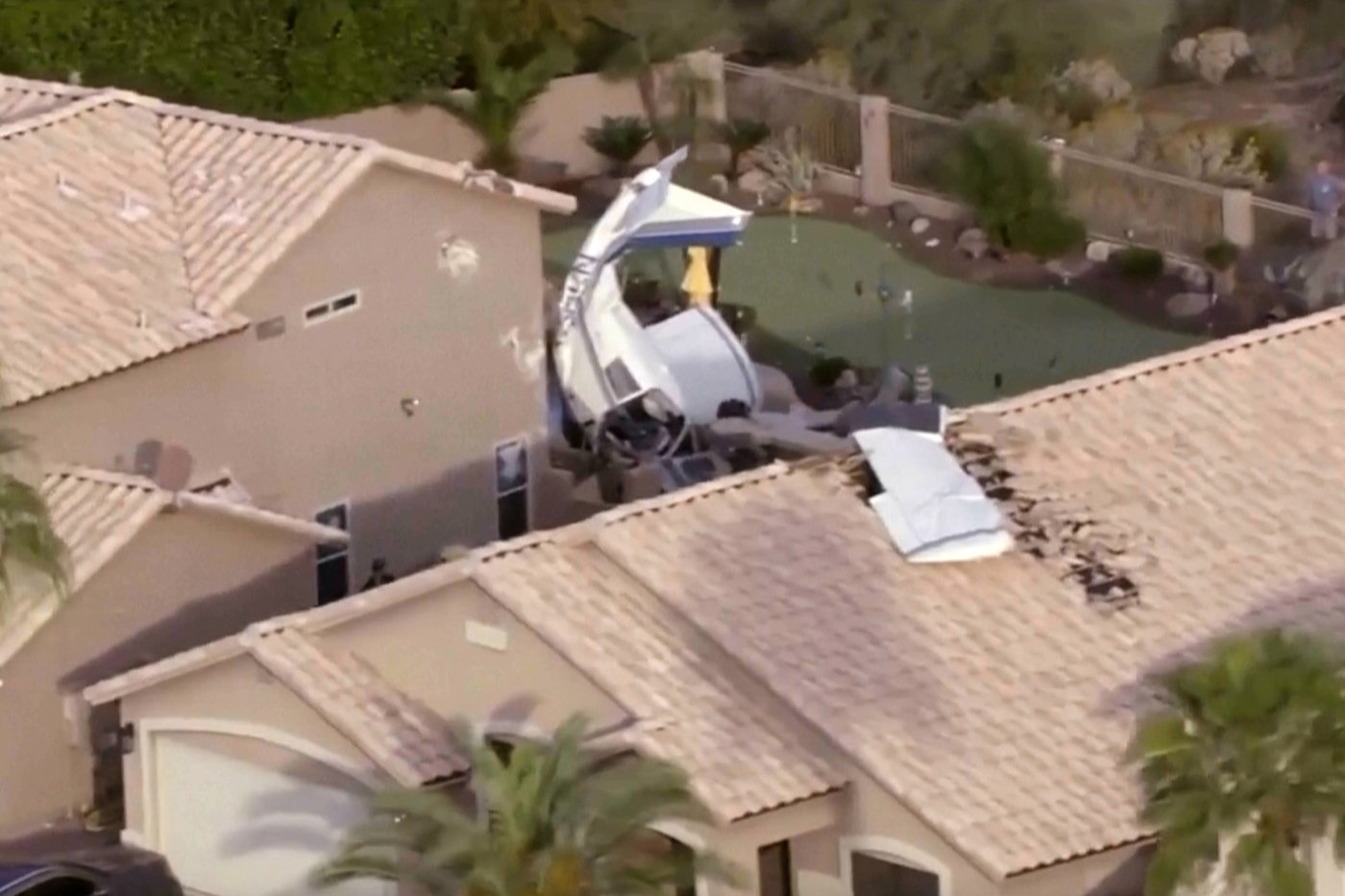 Small plane strikes homes in Phoenix and crashes nose-down next to backyard pool, injuring 3 | iNFOnews.ca