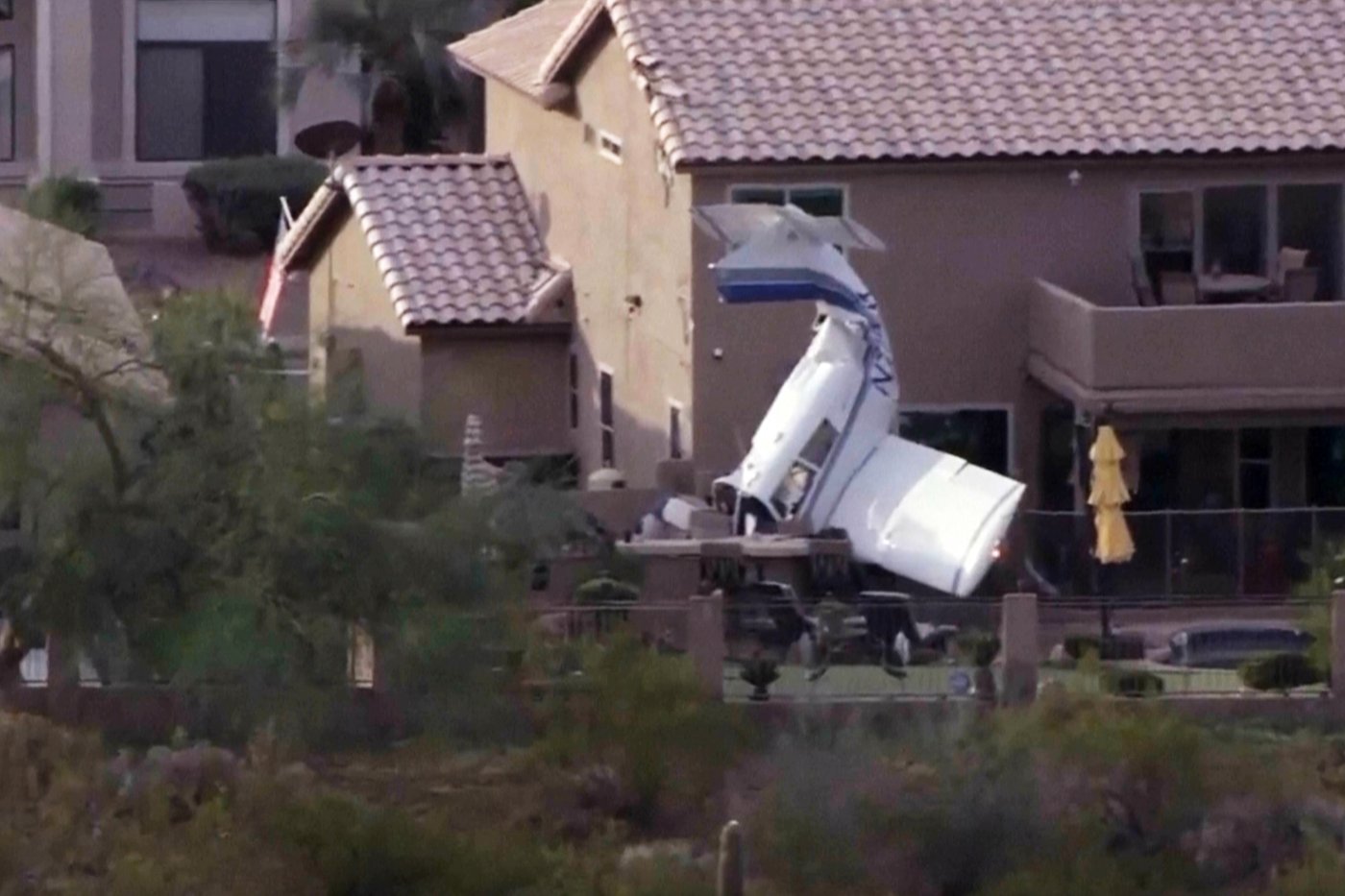 Small plane strikes homes in Phoenix and crashes nose-down next to backyard pool, injuring 3 | iNFOnews.ca