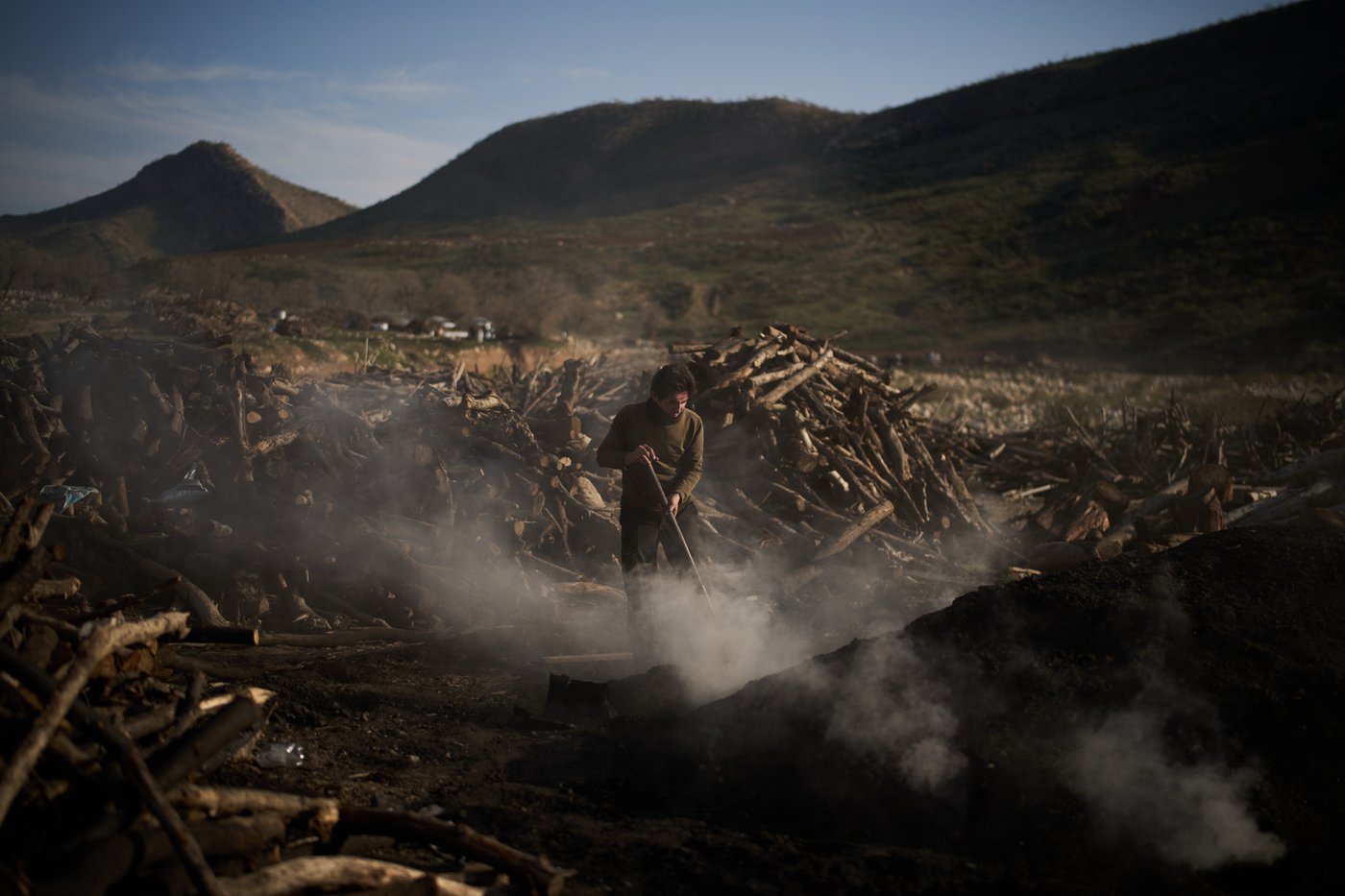 Photos: Charcoal workers in a quiet Kurdish village carry on as war unfolds | iNFOnews.ca