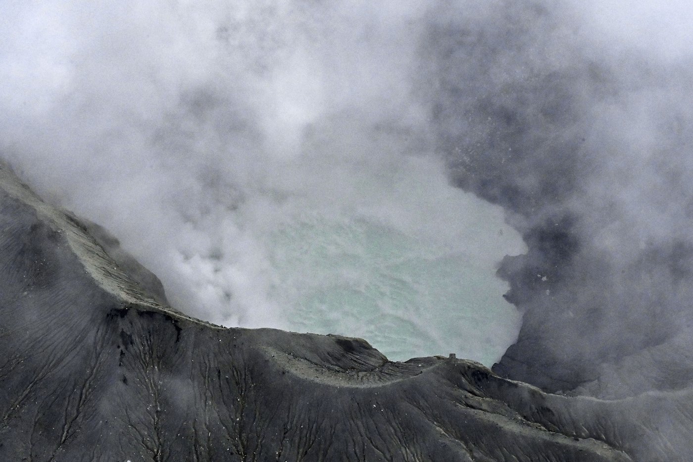 Rescuers spot wreckage possibly from a helicopter that went missing near a volcano in Japan | iNFOnews.ca