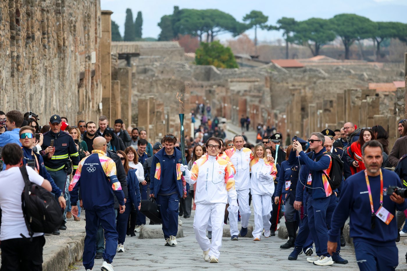 Jackie Chan carries the Milan Cortina Olympic torch through the ruins of Pompeii | iNFOnews.ca
