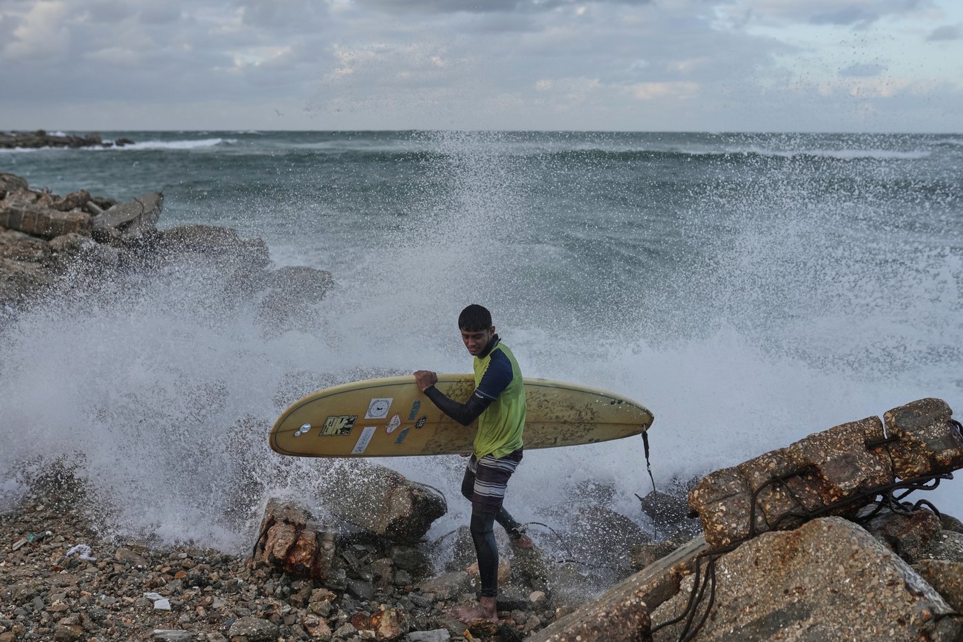 Photos show surfers riding waves along Gaza City’s damaged coastline | iNFOnews.ca