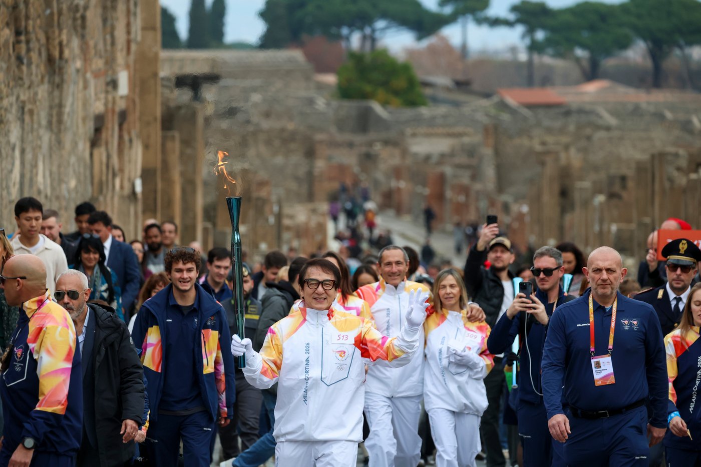 Jackie Chan carries the Milan Cortina Olympic torch through the ruins of Pompeii | iNFOnews.ca