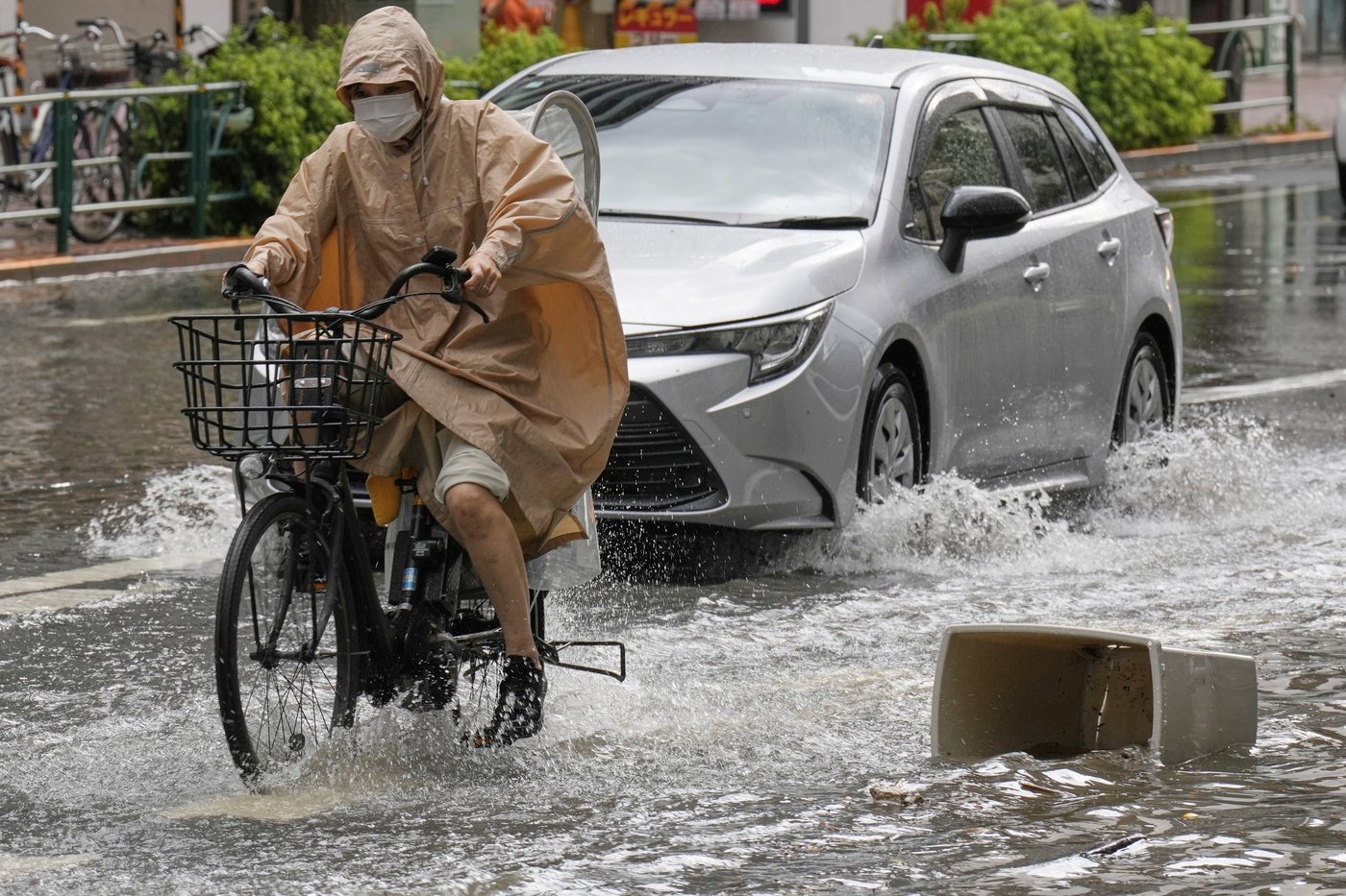 Sudden deluge of rain floods some streets and halts air and rail traffic in Tokyo | iNFOnews.ca