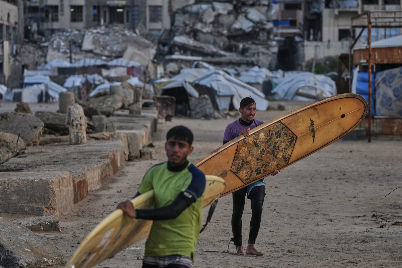Photos show surfers riding waves along Gaza City’s damaged coastline | iNFOnews.ca