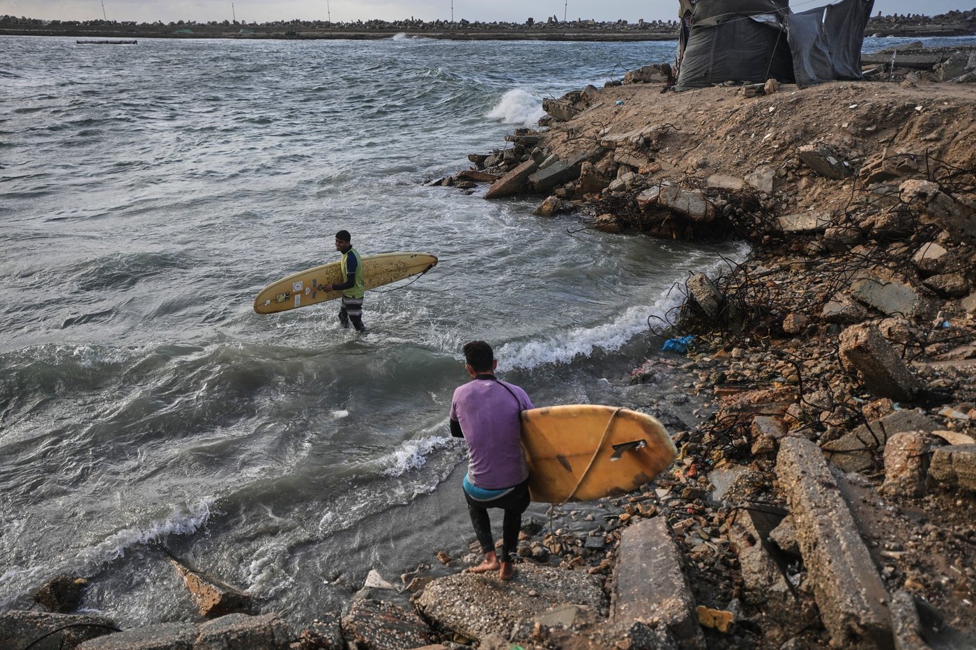 Photos show surfers riding waves along Gaza City’s damaged coastline | iNFOnews.ca
