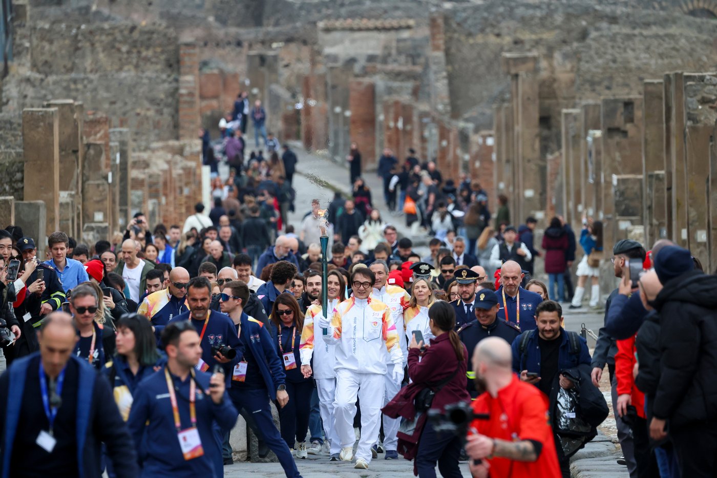 Jackie Chan carries the Milan Cortina Olympic torch through the ruins of Pompeii | iNFOnews.ca