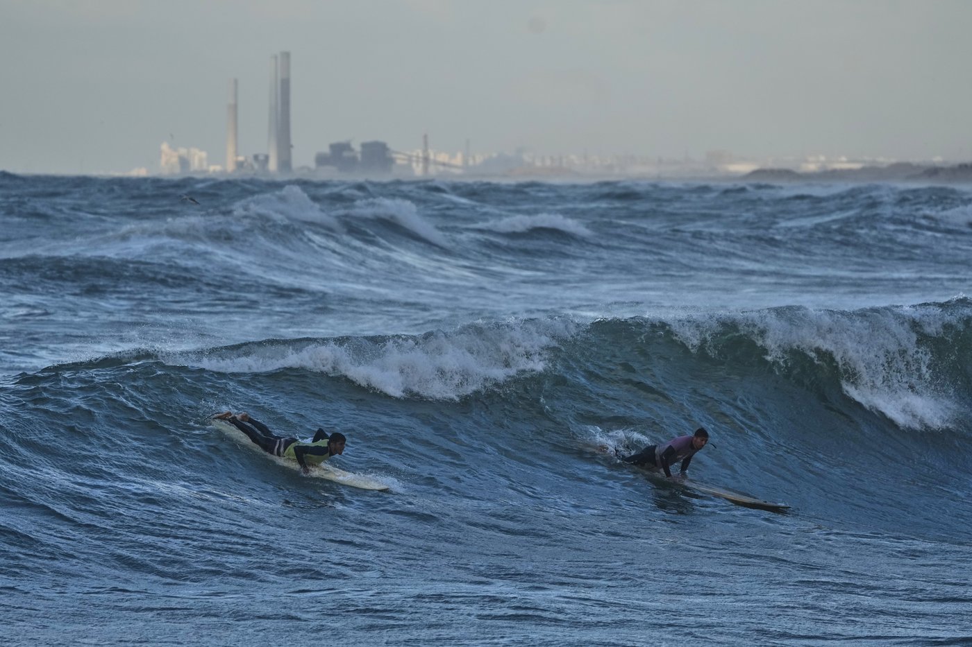 Photos show surfers riding waves along Gaza City’s damaged coastline | iNFOnews.ca