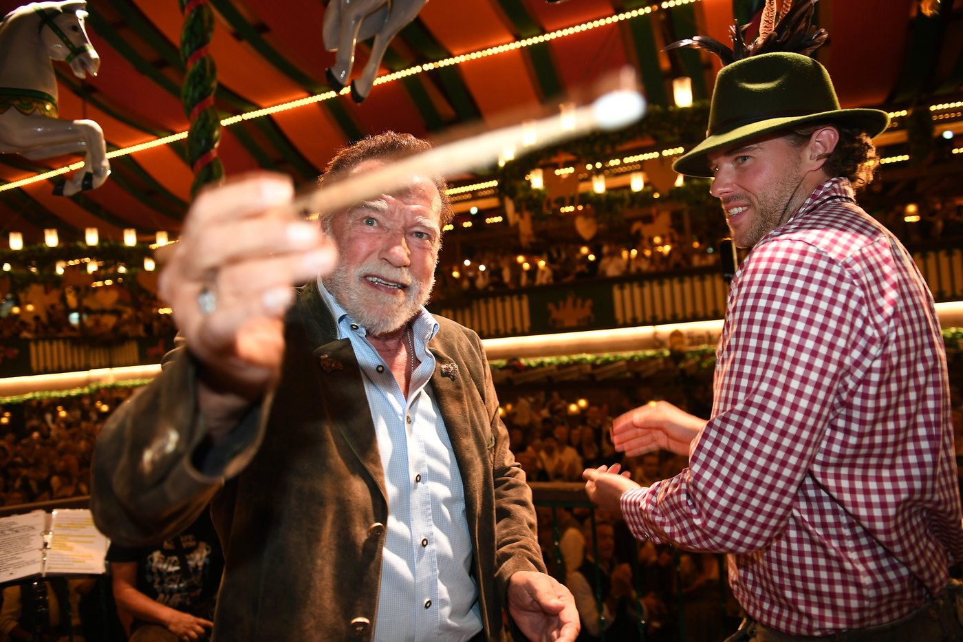 Schwarzenegger directs a band in a beer tent at Munich's Oktoberfest | iNFOnews.ca