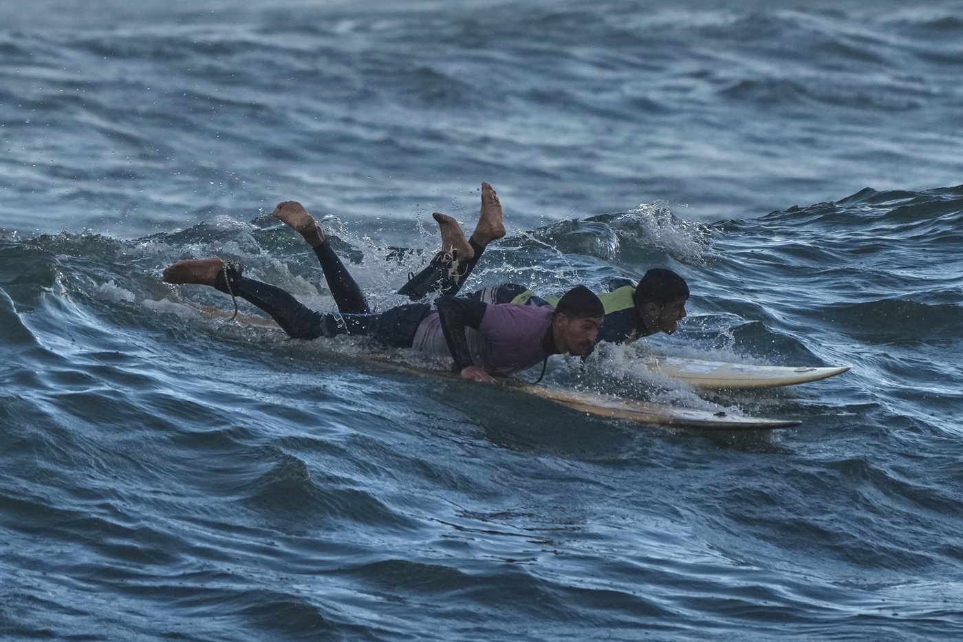 Photos show surfers riding waves along Gaza City’s damaged coastline | iNFOnews.ca