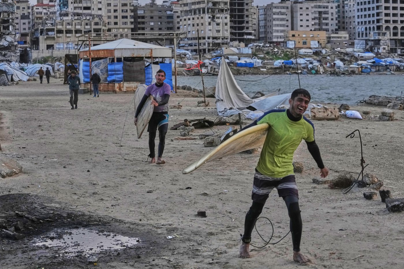 Photos show surfers riding waves along Gaza City’s damaged coastline | iNFOnews.ca