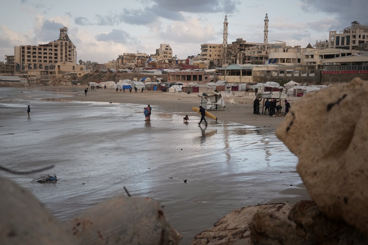 Photos show surfers riding waves along Gaza City’s damaged coastline | iNFOnews.ca