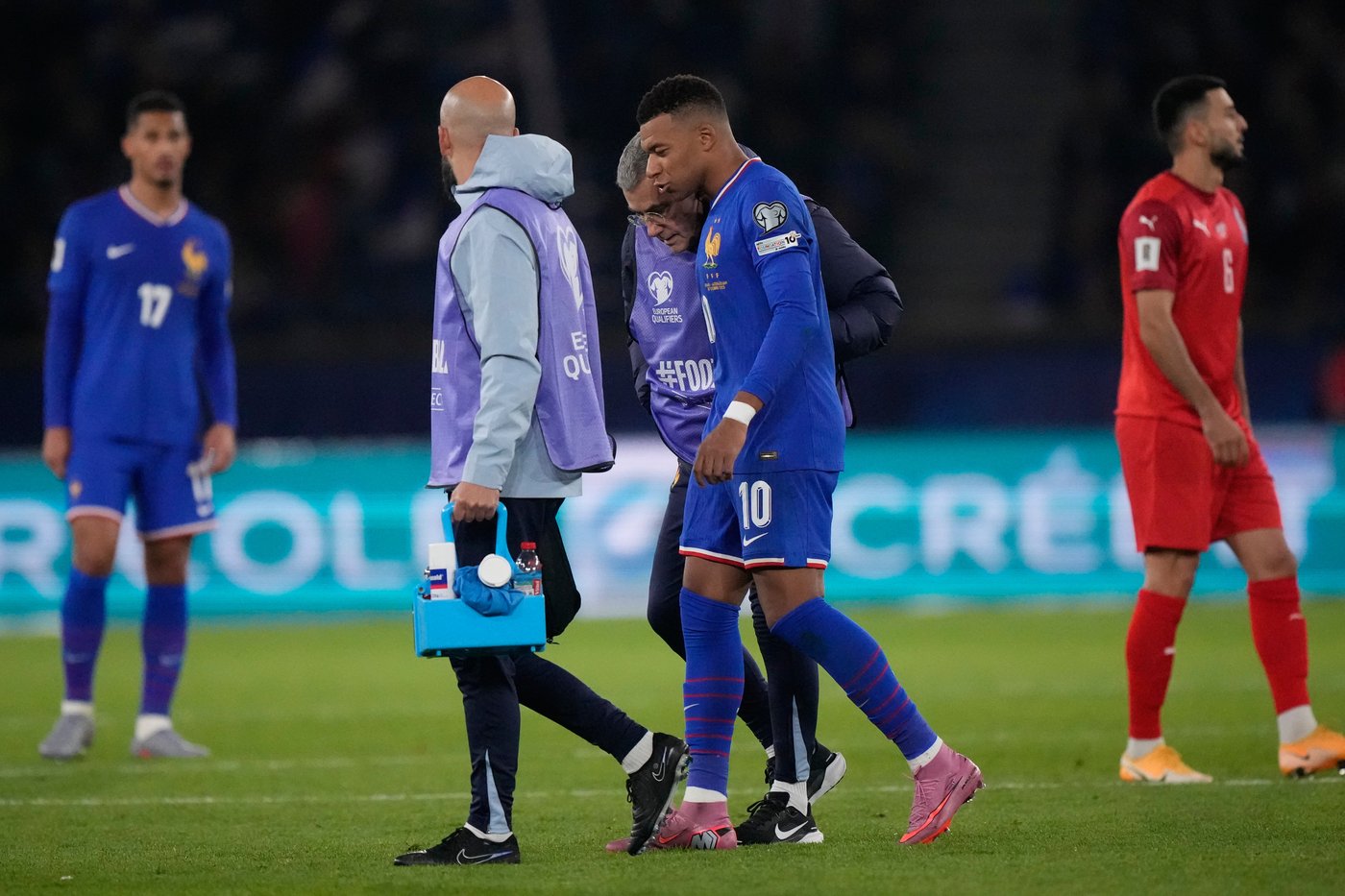 Mbappé scores but limps off late in France's World Cup qualifying win. Germany gets boost | iNFOnews.ca Mbappé scores but limps off late in France's World Cup qualifying win. Germany gets boost | iNFOnews.ca