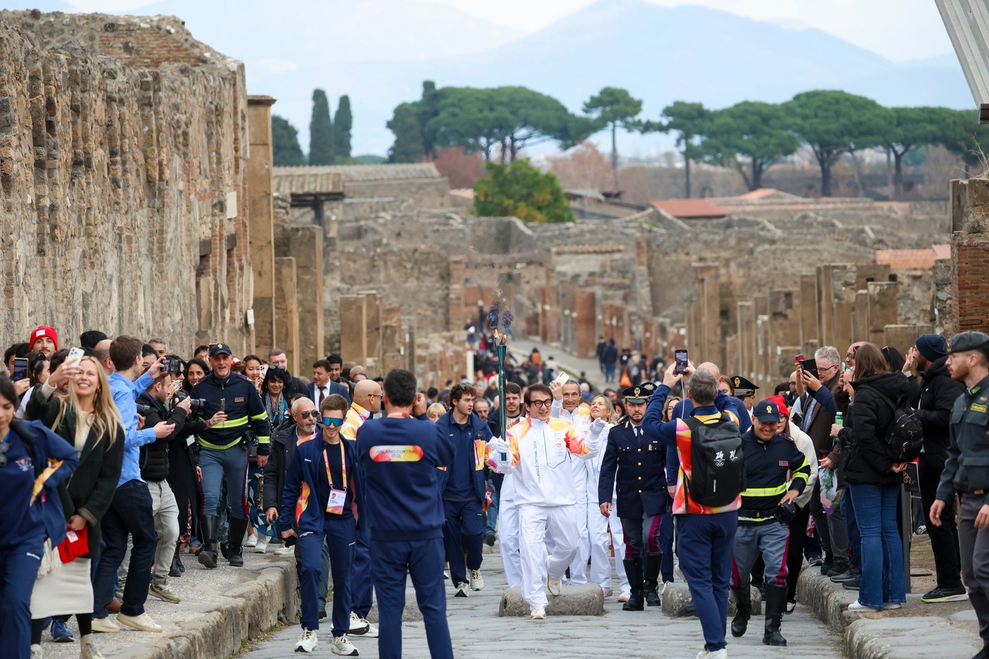 Jackie Chan carries the Milan Cortina Olympic torch through the ruins of Pompeii | iNFOnews.ca